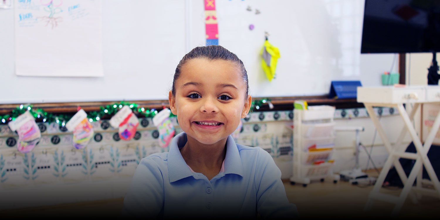 Smiling elementary student in a classroom