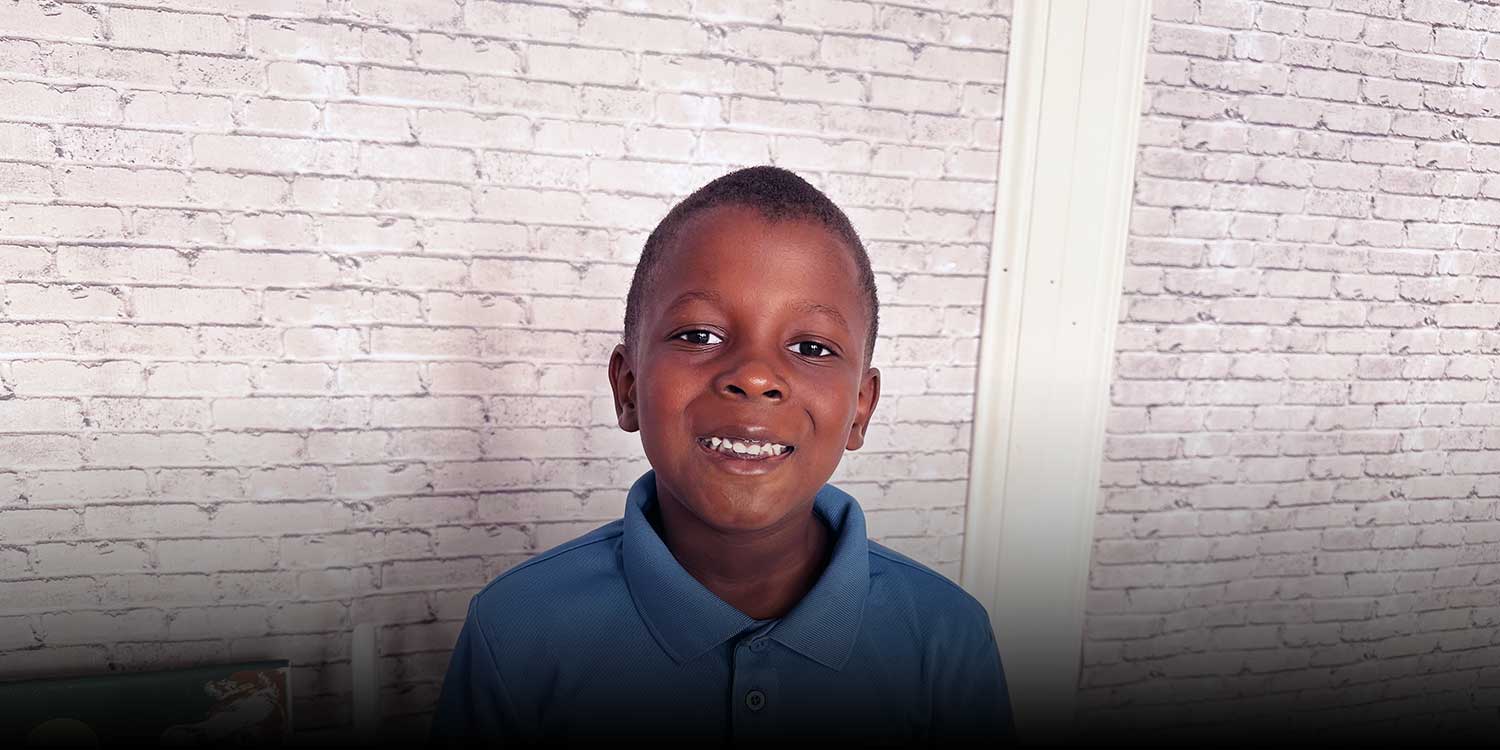 Smiling student wearing Mosiac Classical uniform